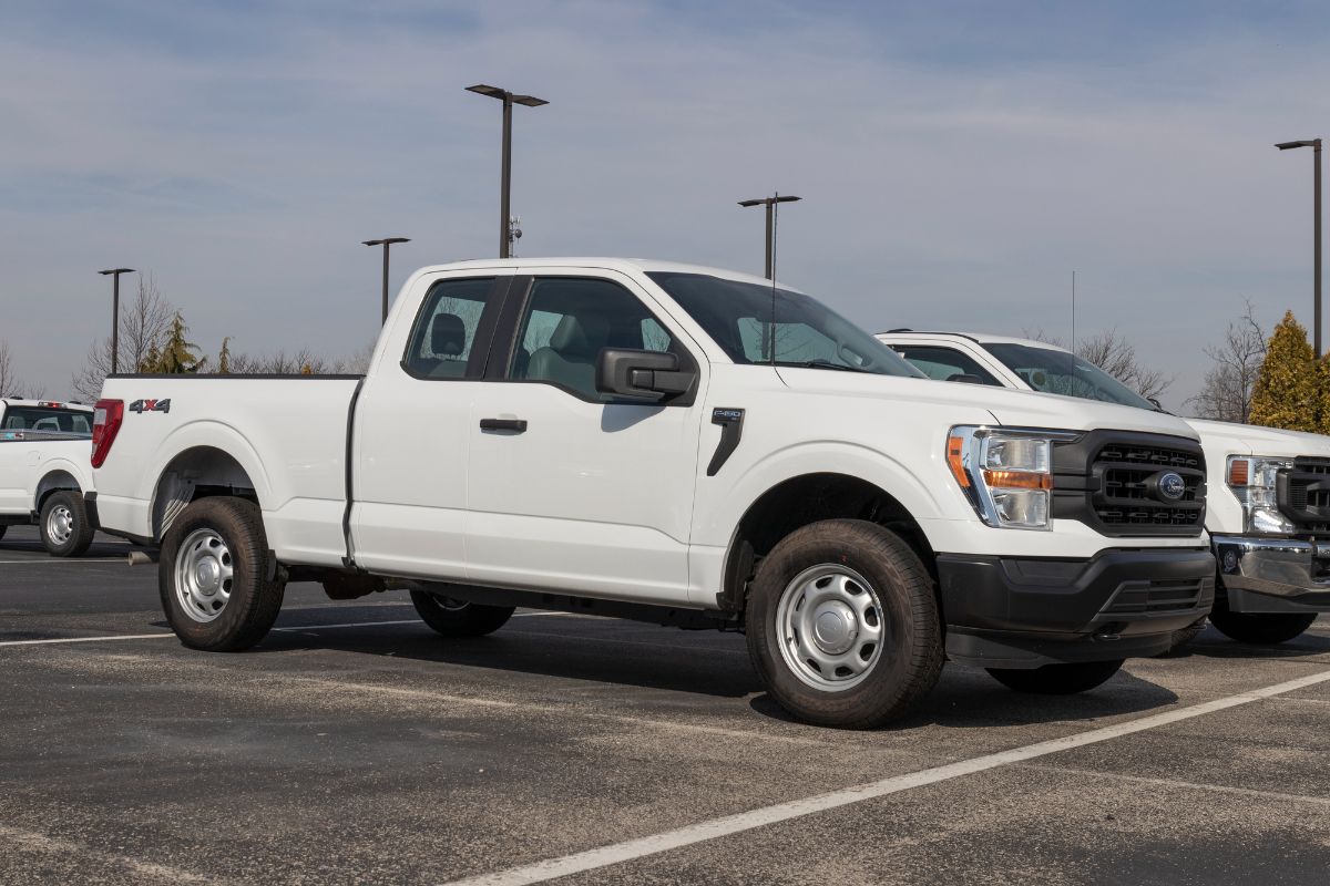 A side view of a white 2022 Ford F-150 in parking area.