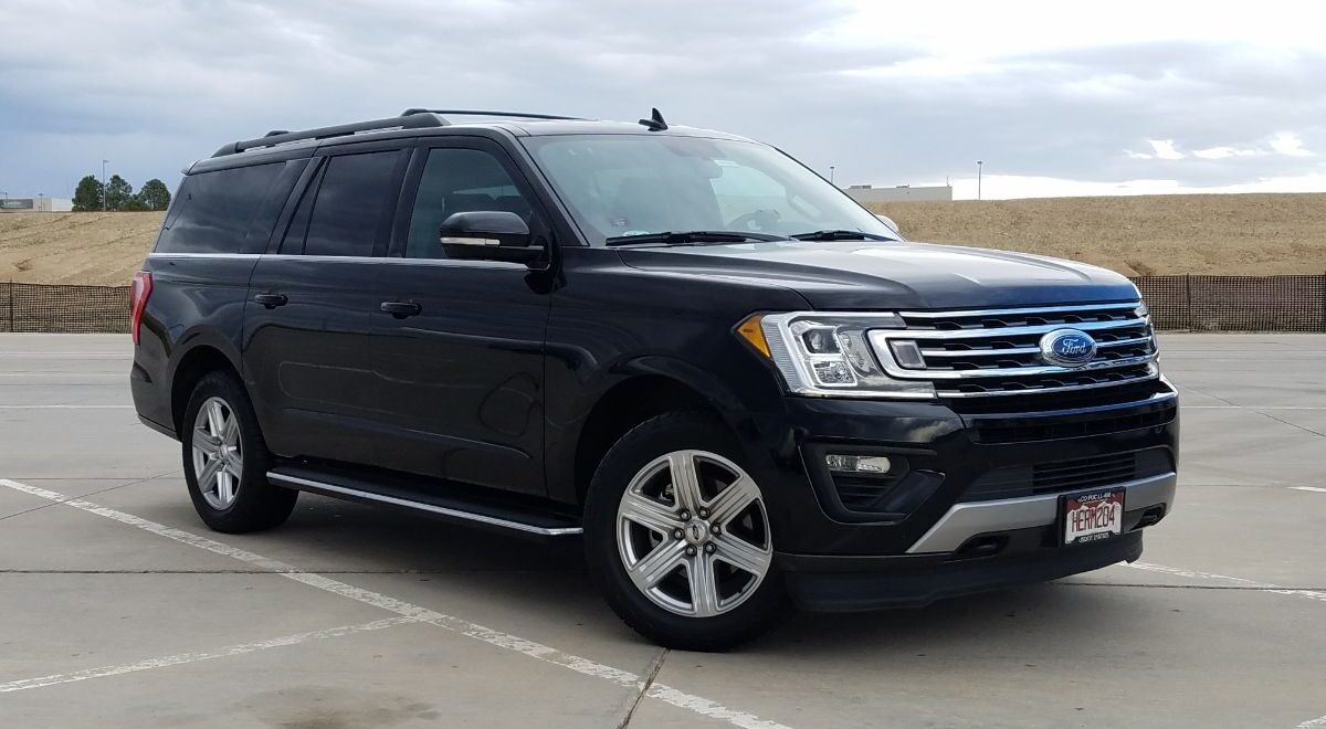 Side view photo of ford expidition in a empty parking space.