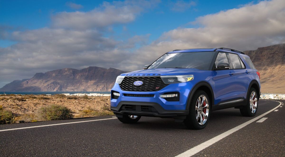 A blue ford explorer in the middle of the road.