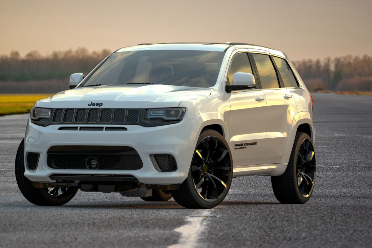 Front view of white grand jeep cherokee in middle of road.