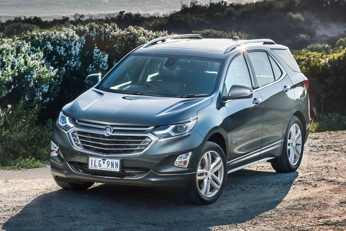 A shining holden equinox car photographed with the plants at the back.