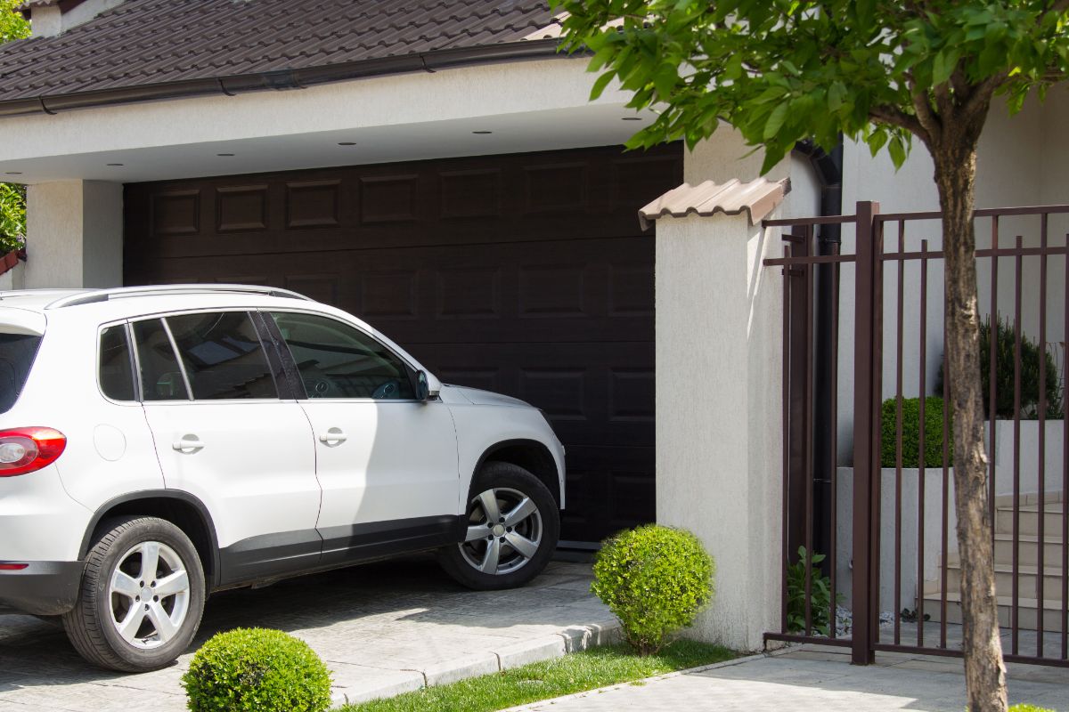 A white car about to get in at the garage.