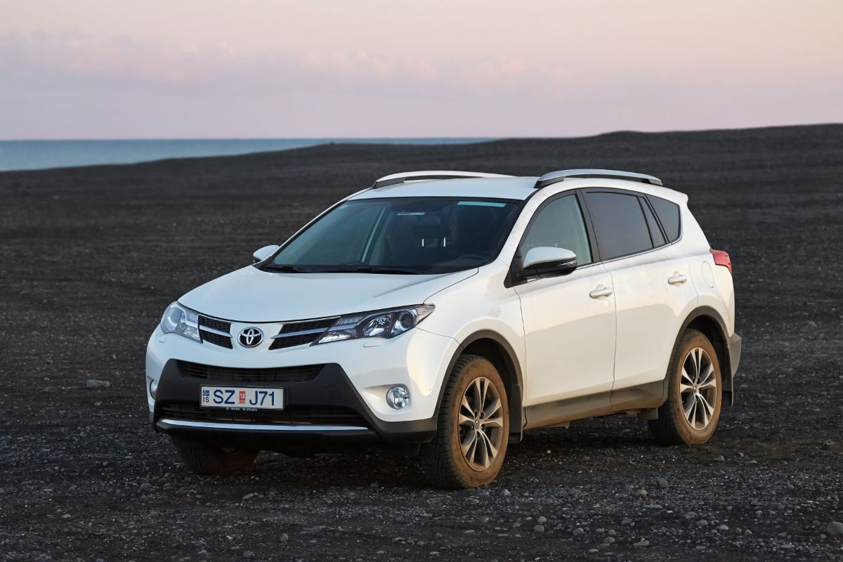 A white toyota rav4 on the terrain.