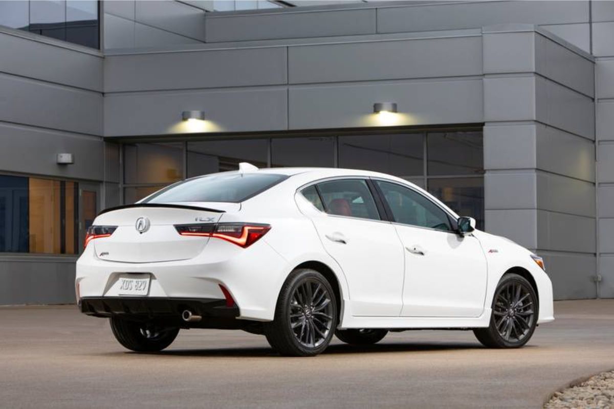 Back and side view of white color acura ilx.