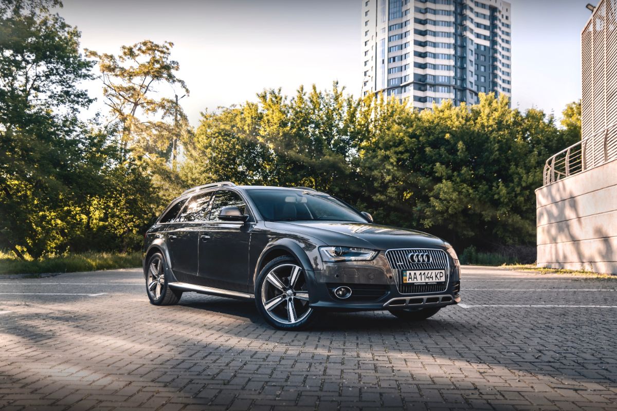 A photo of brown color audi car displayed outside.