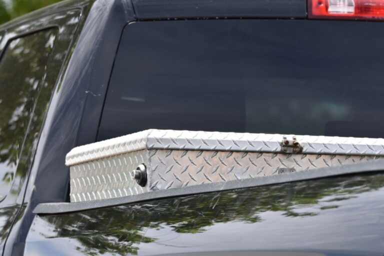 A close up photo of an aluminom tool box placed in the truck bed.