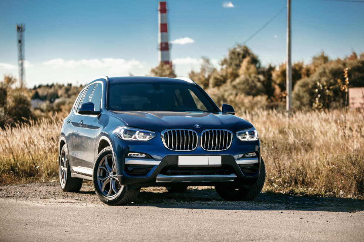 Front view of bmw car with tall grass background.