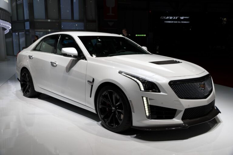 Front and side view of white cadillac ct6 at the auto show.