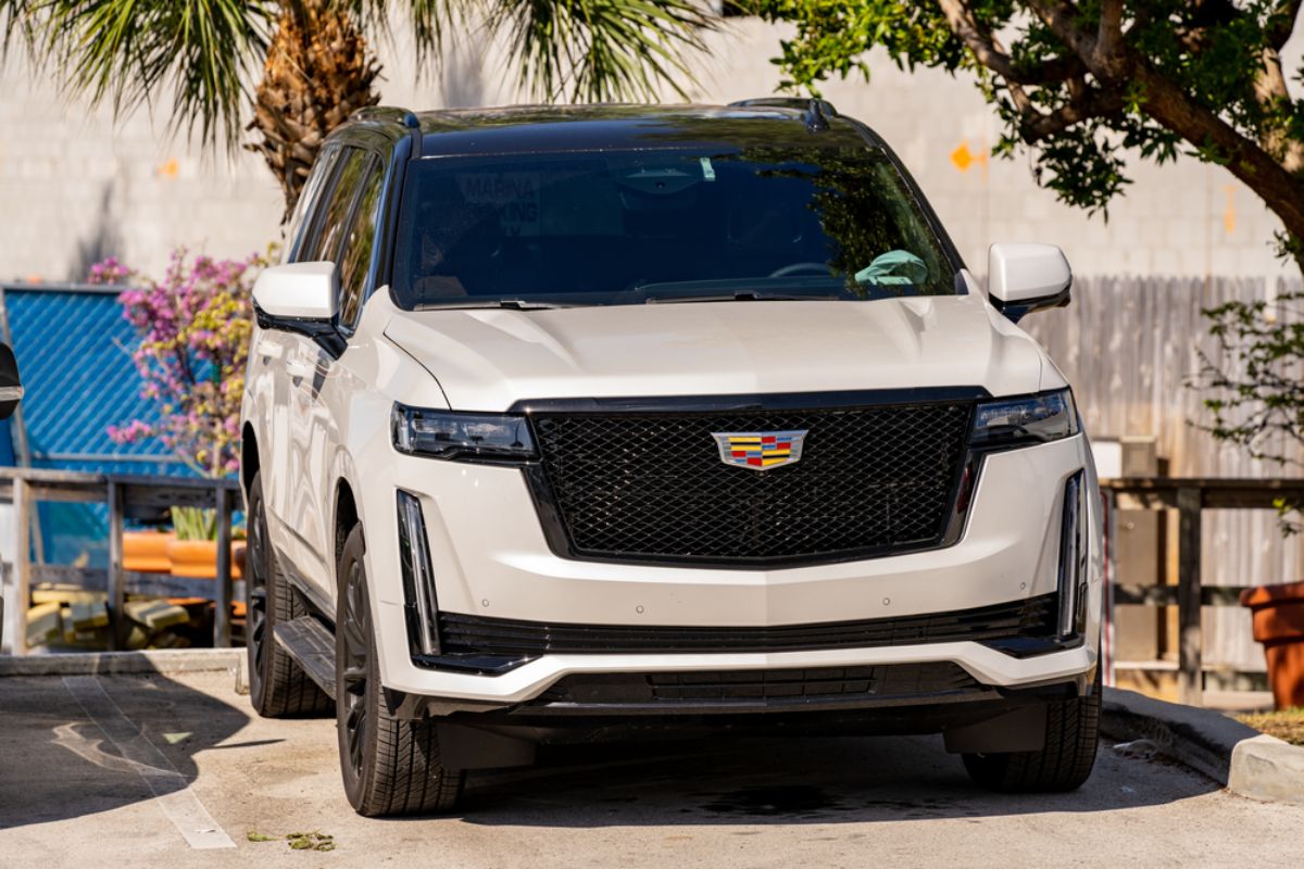 Black and White luxurious Cadillac Escalade parked at the sunny streets somewhere at Florida, USA. 