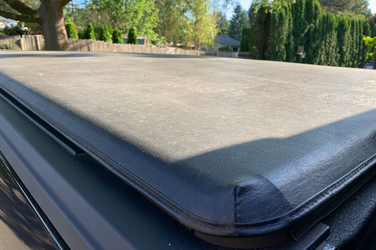 Close up view of black truck bed tonneau cover.