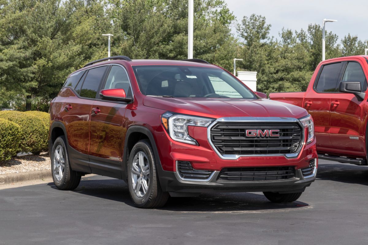 Brand new 2022 model of a Red GMC Yukon XL Denali at a SUV dealership.