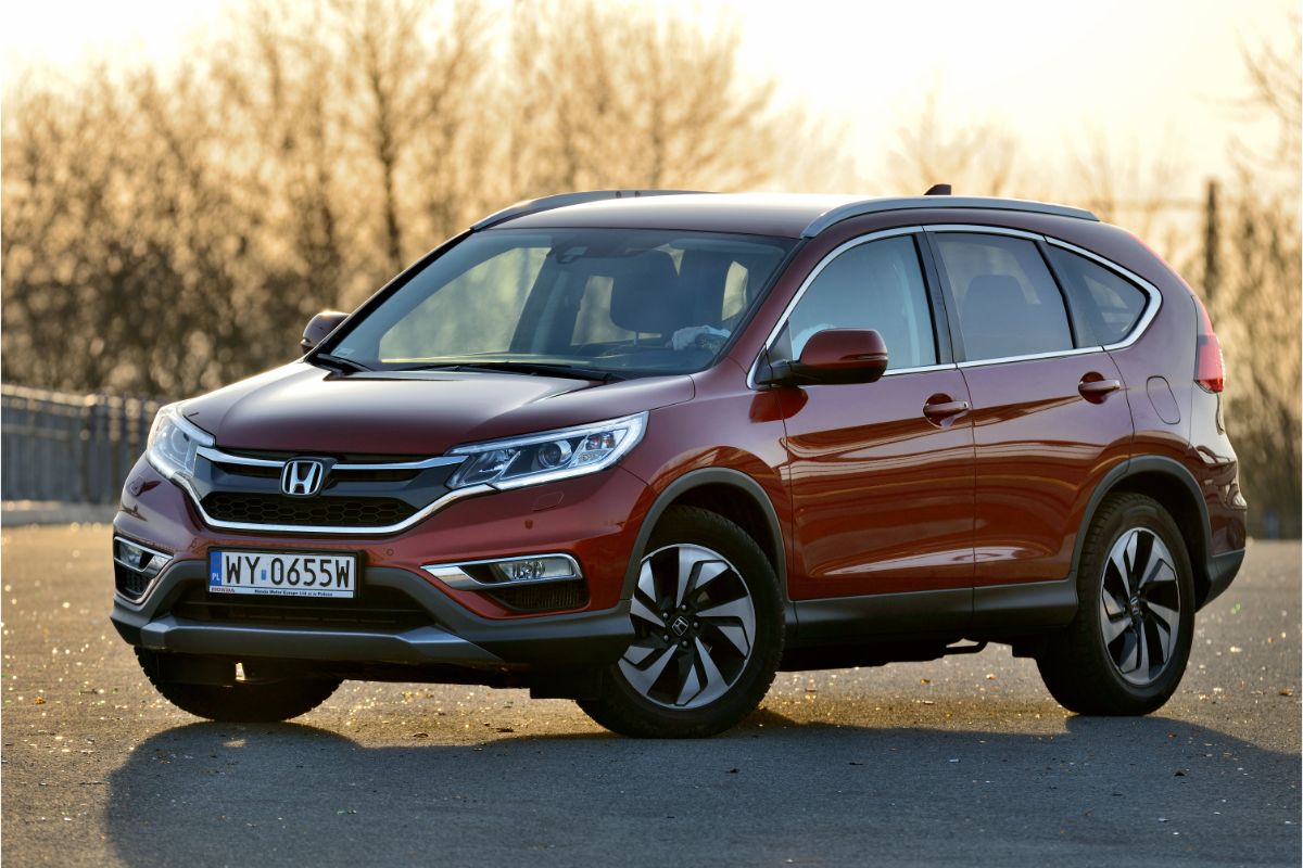 Front and side view of honda cr v in the middle of the street.