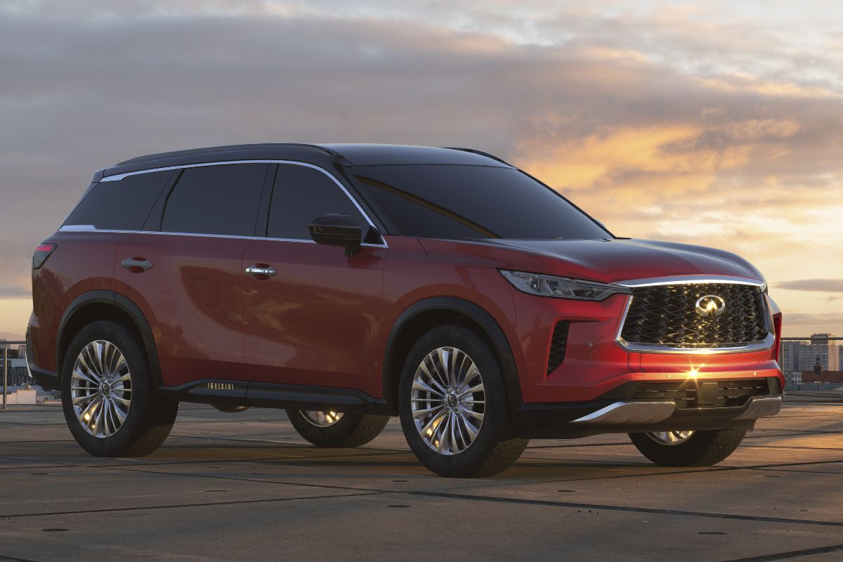 Side view image of red Infiniti QX60 parked at rooftop.