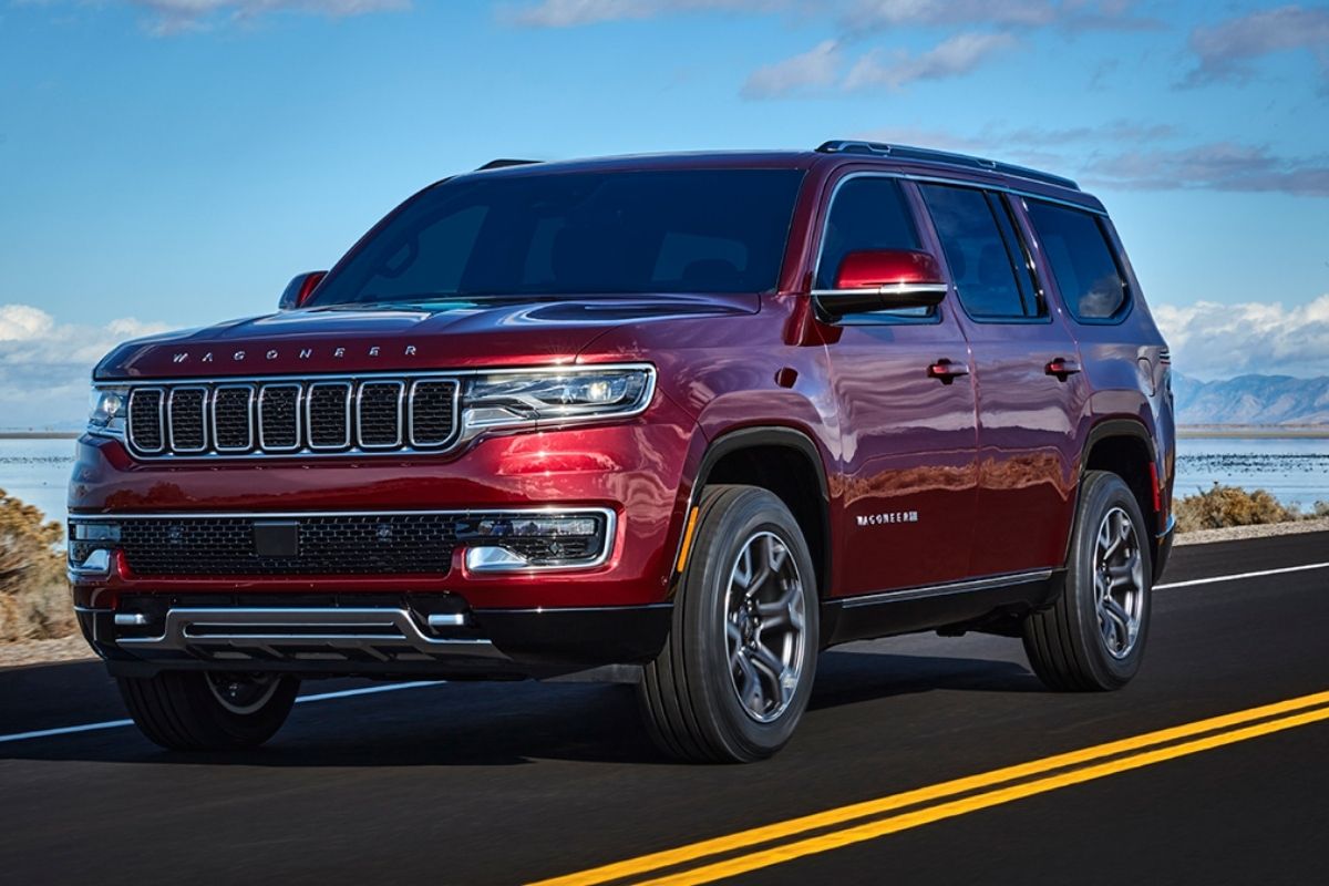 2021 maroon Jeep Grand Wagoneer at the highway side angle featuring it's specs.