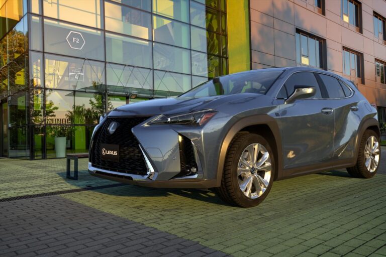 Side view photo of lexus ux in the parking lot of a modern office building.