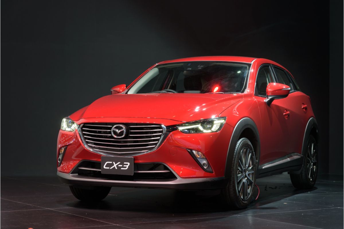 Mazda CX-3 isolated in a gray background in a red colorway.