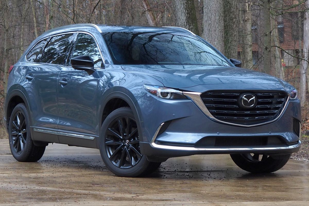 The brand new Mazda CX-9 2022 model captured parking at the woods in the background.