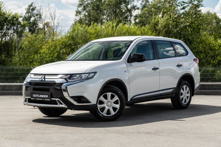 A photo of mitsubishi outlander in a white color parked outside.