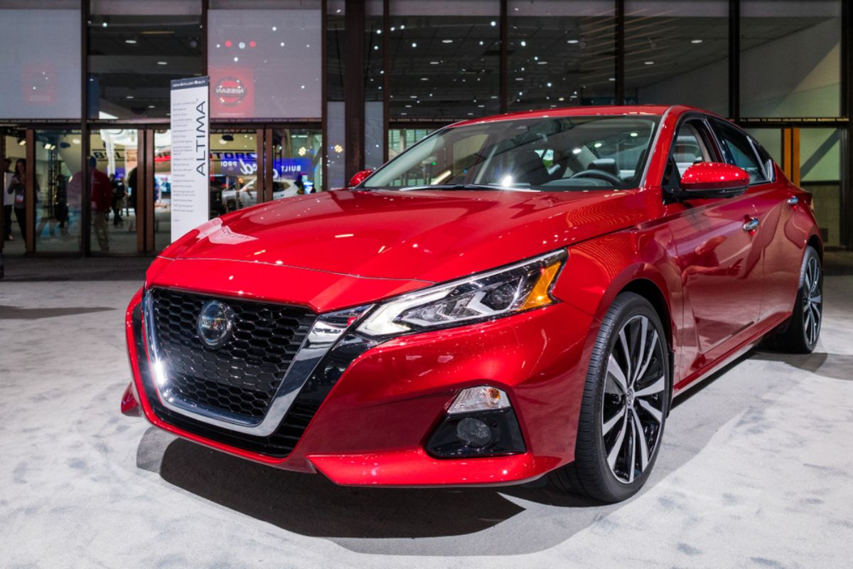 Brand new Nissan Altima in a metallic red colorway in display at the Los Angeles Auto Show.