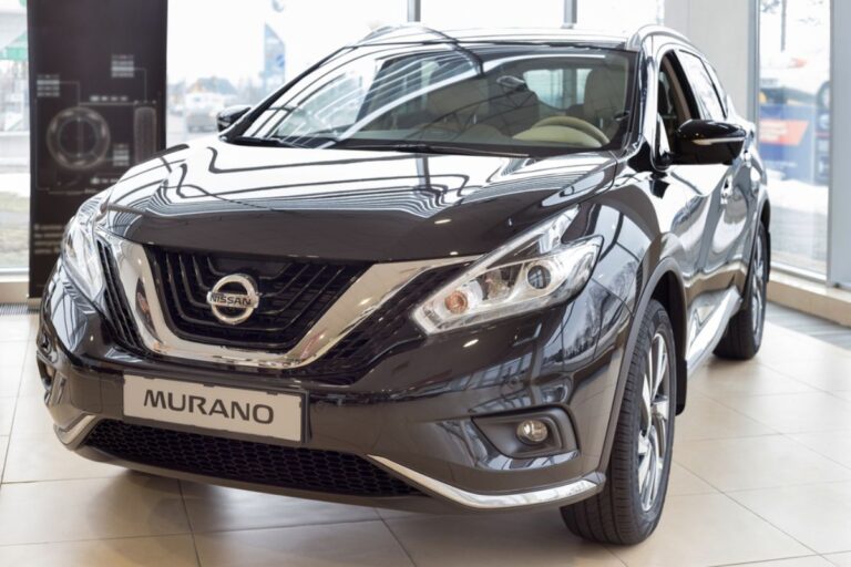 Front side view angle of a Nissan Murano in a metallic black colorway in dsiplay at the automobile dealership.