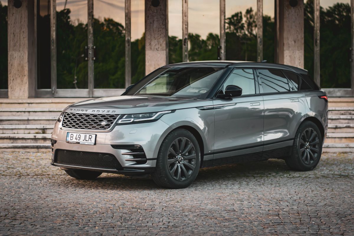 Front and side view of new range rover velar car displayed outside.