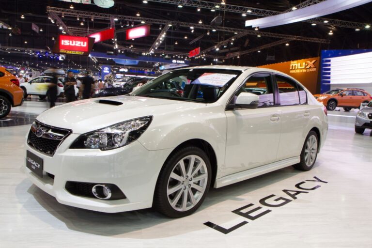 Side view angle of white Subaru Legacy in display at The 30th Thailand International Motor Expo.