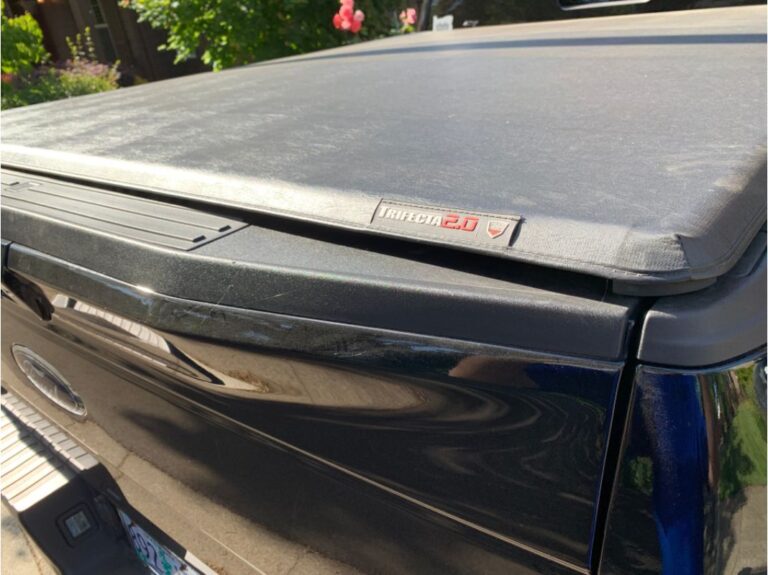 Close up view of black truck bed tonneau cover of a Trifecta truck.