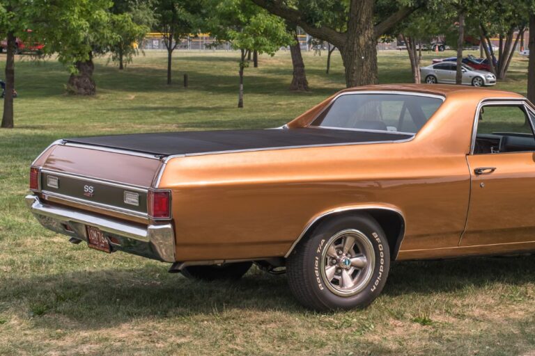 Side and back view of car on the gran with tonneau cover.