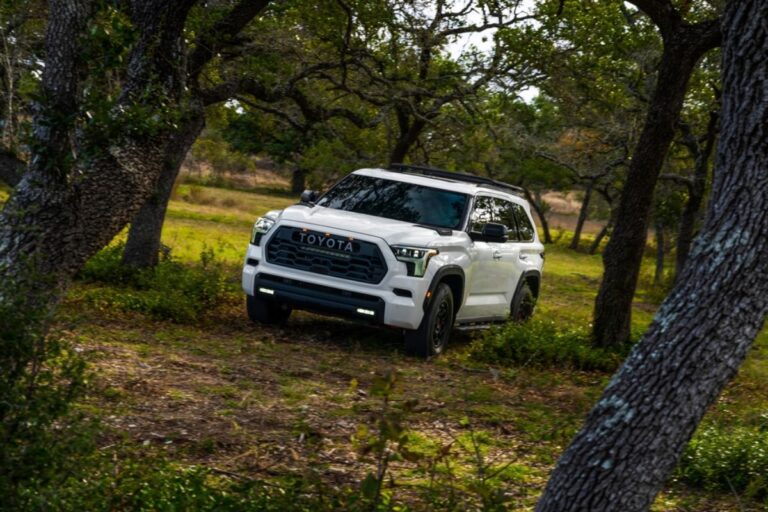 The all new 2023 model Toyota Sequoia in a white colorway doing a test drive in a challenging terrain.