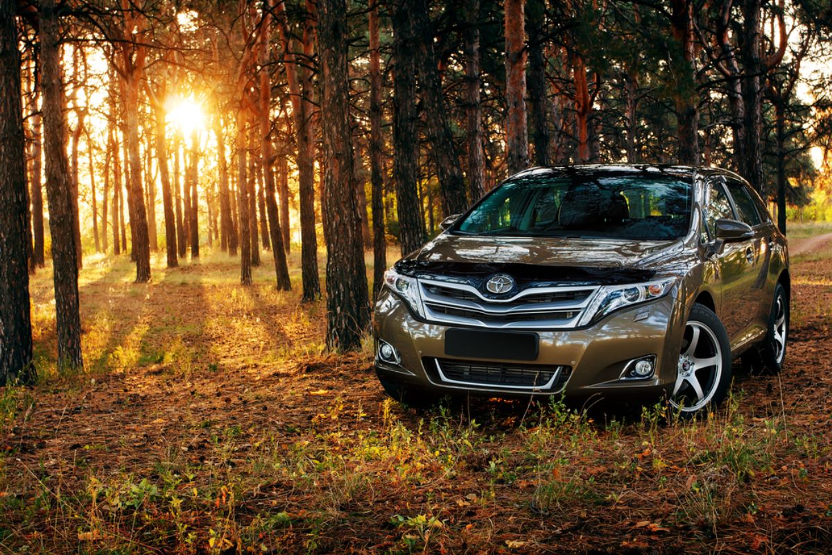 Toyota Venza spotted parking at the forest with a beautiful sunset on the background.