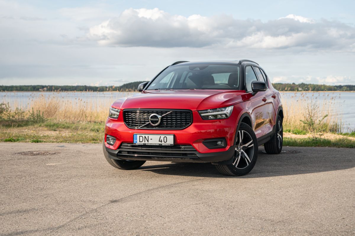 Front view photo of red volvo xc40 near river side.