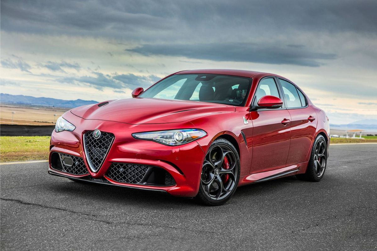 A picture of red luxury car driving at the country side road.