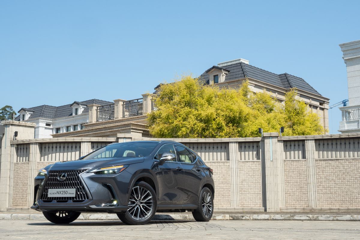 Front and side view of black 2022 Lexus NX parked outside of the big house.