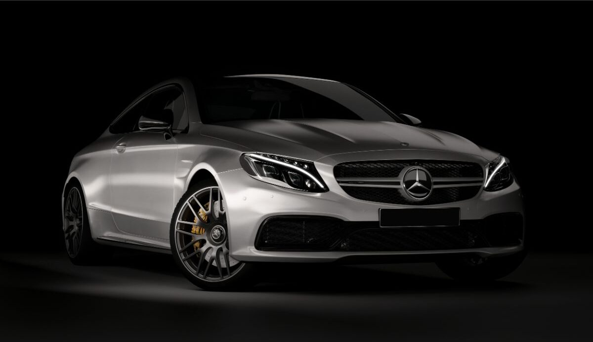 Front shot of a gleaming Metallic-silver Mercedes AMG S63/S65 on a black background.