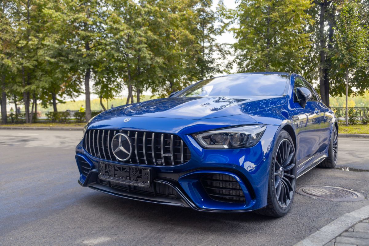 Front view ofa blue car Mercedes-AMG GT 43 parked outdoor on street background.