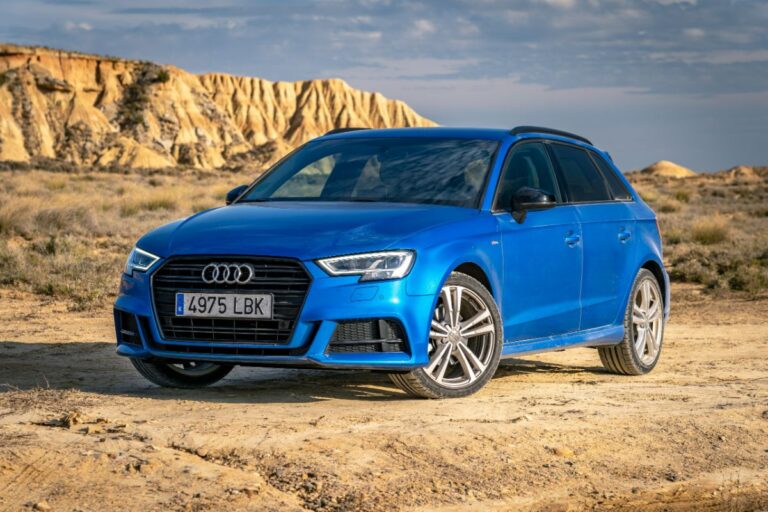 Blue Audi A3 parked in a picturesque location overseeing the desert mountain.