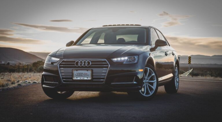 Front view of Audi A4 at sunset overlooking the mountains.