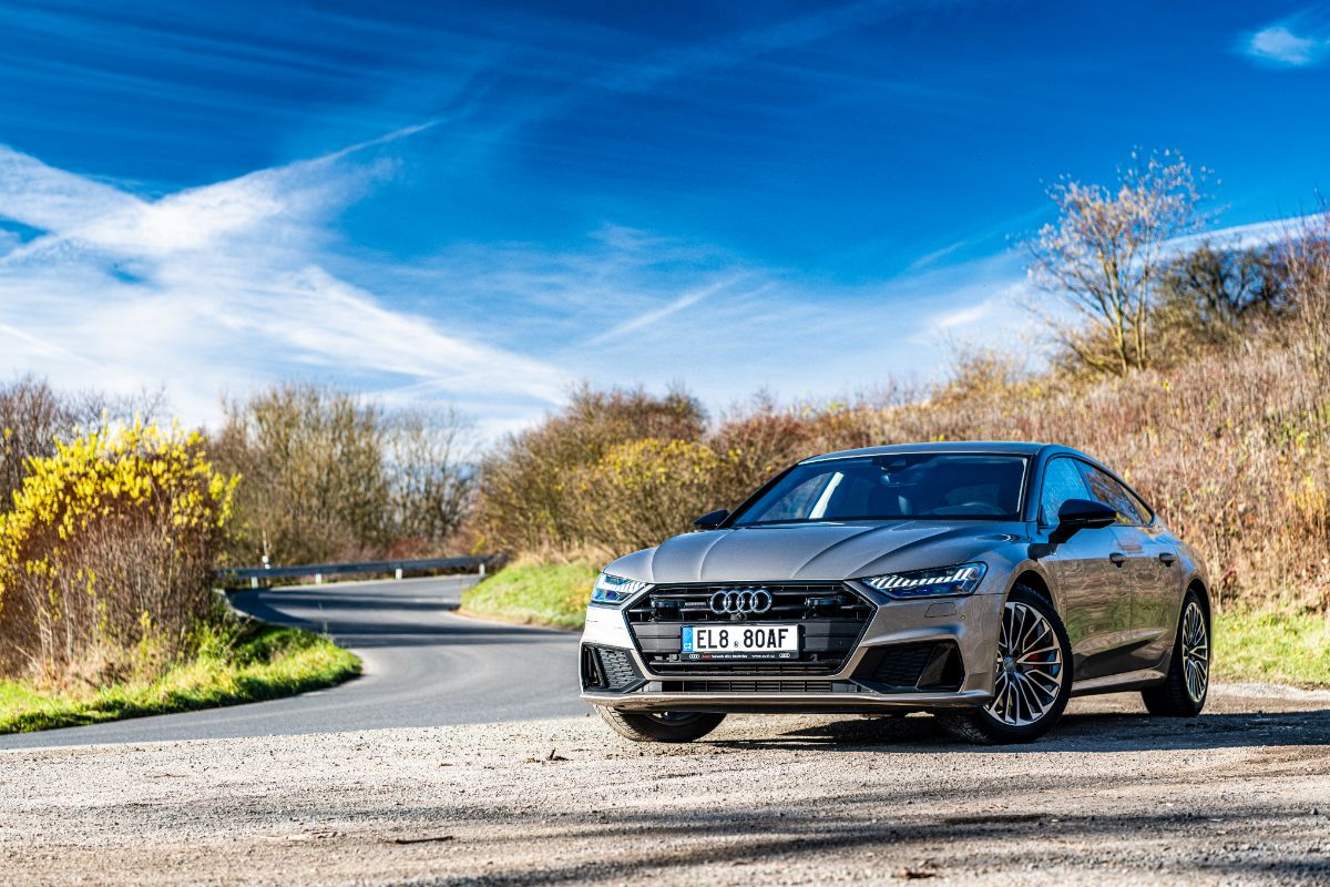 A photo of Audi A7 car parked at the side of road in nature.