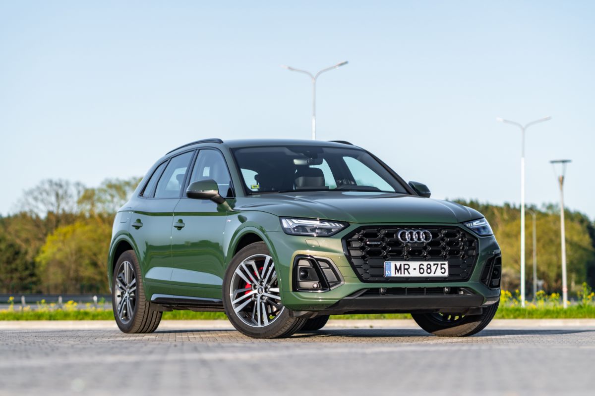 Green colored Audi Q5 car photographed at the parking space.