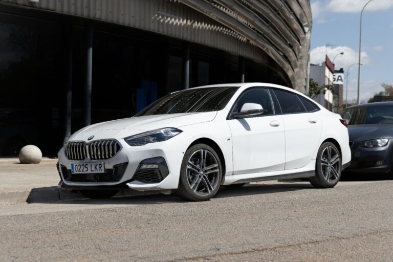 Side view look of a white BMW 2 Series at the city street parked.