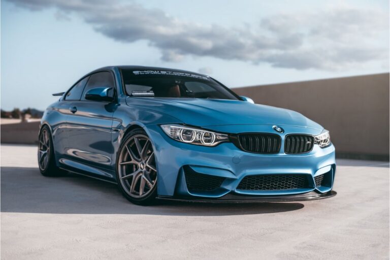 A blue BMW M4 car on the parking lot at morning.