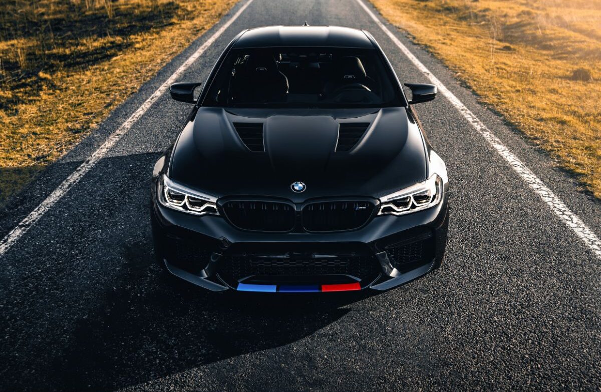 High angle view of black BMW M5 driving on the road.