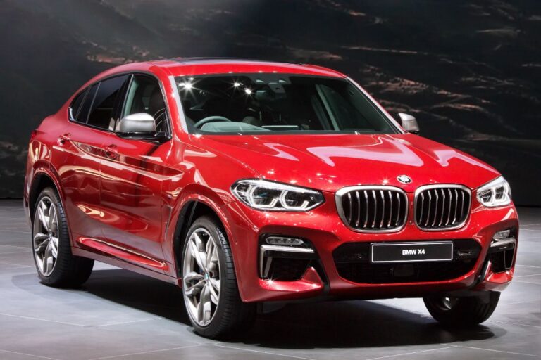 Front side view of the all new BMW X4 in metallic red colorway displayed at the Geneva Switzerland auto show.