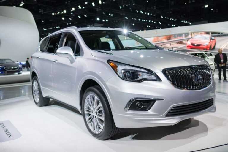 Fron side view of a gleaming gray Buick Envision on display in the auto show.