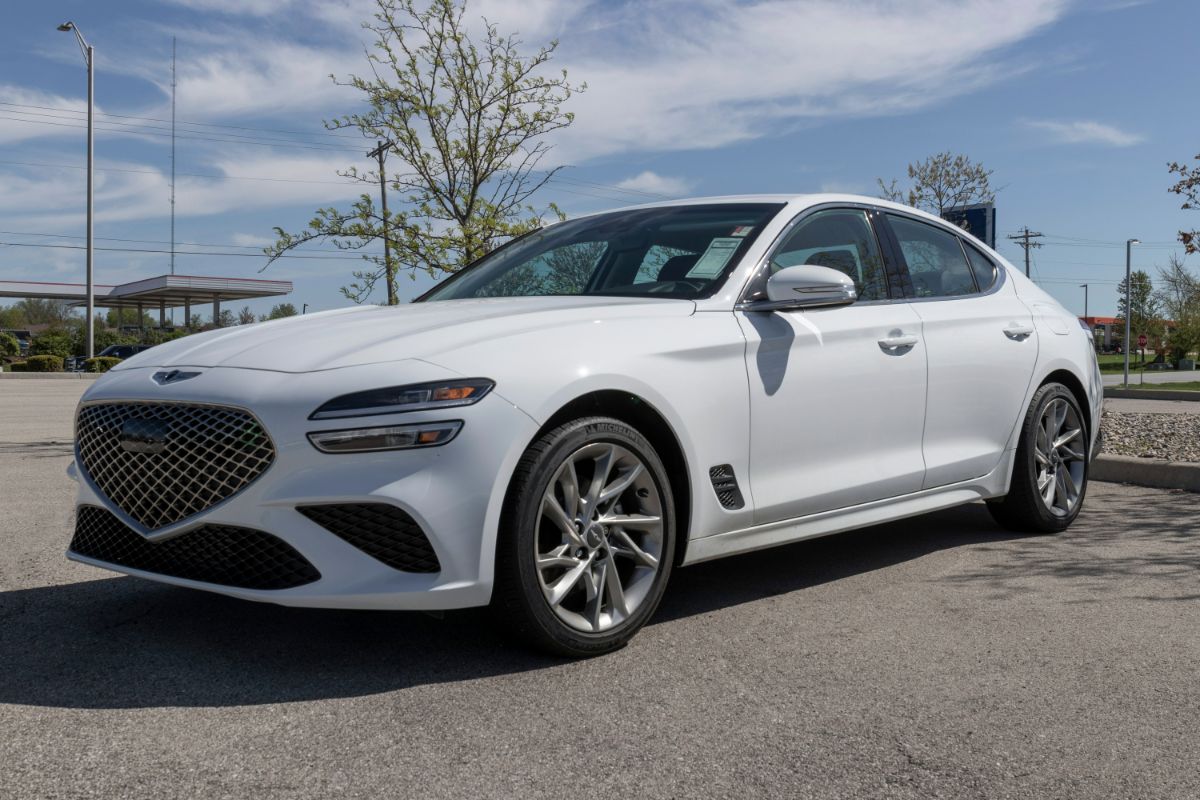 Front view of a white-colored Genesis G70 luxury sedan parked.