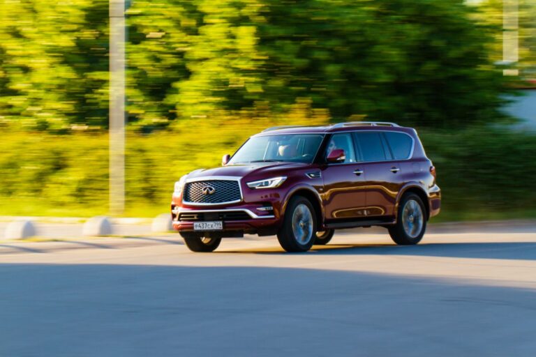 A full-size luxury SUV running on the road in daylight.