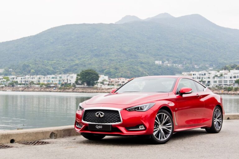 Front and side view shot of red Infiniti Q60 car parked near river.