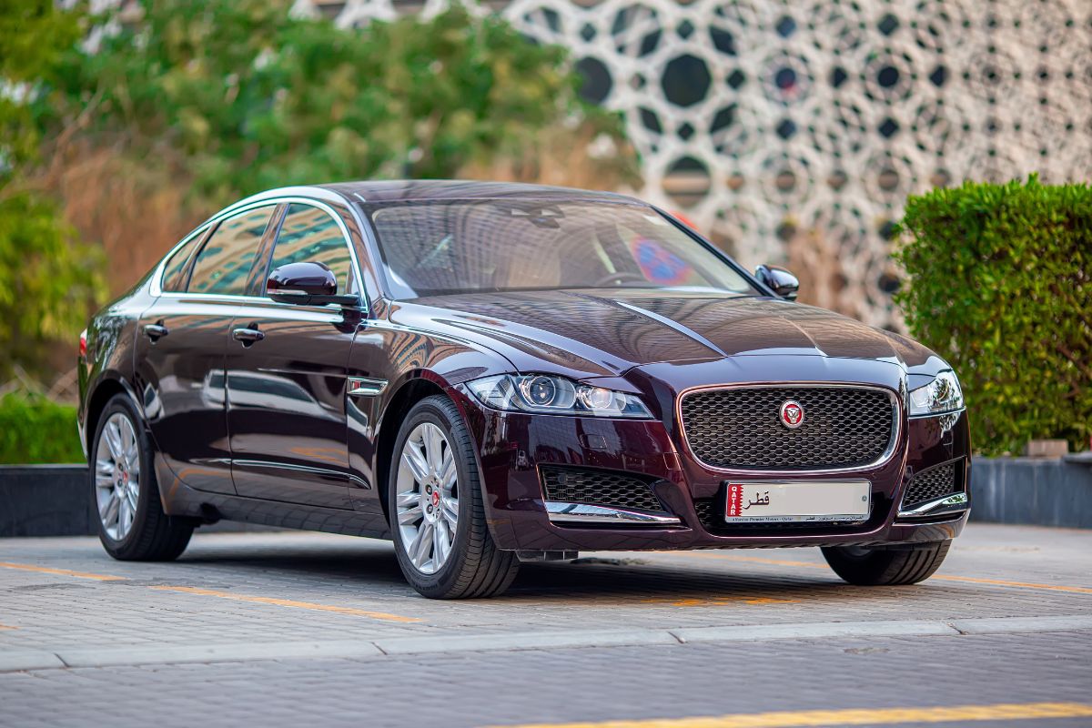 Front and side view of Jaguar XF car parked on the parking lot.