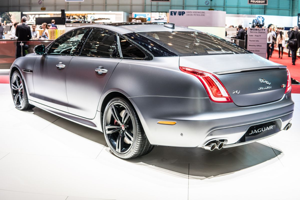 Rear view of a silver-colored Jaguar XJR575 on display.