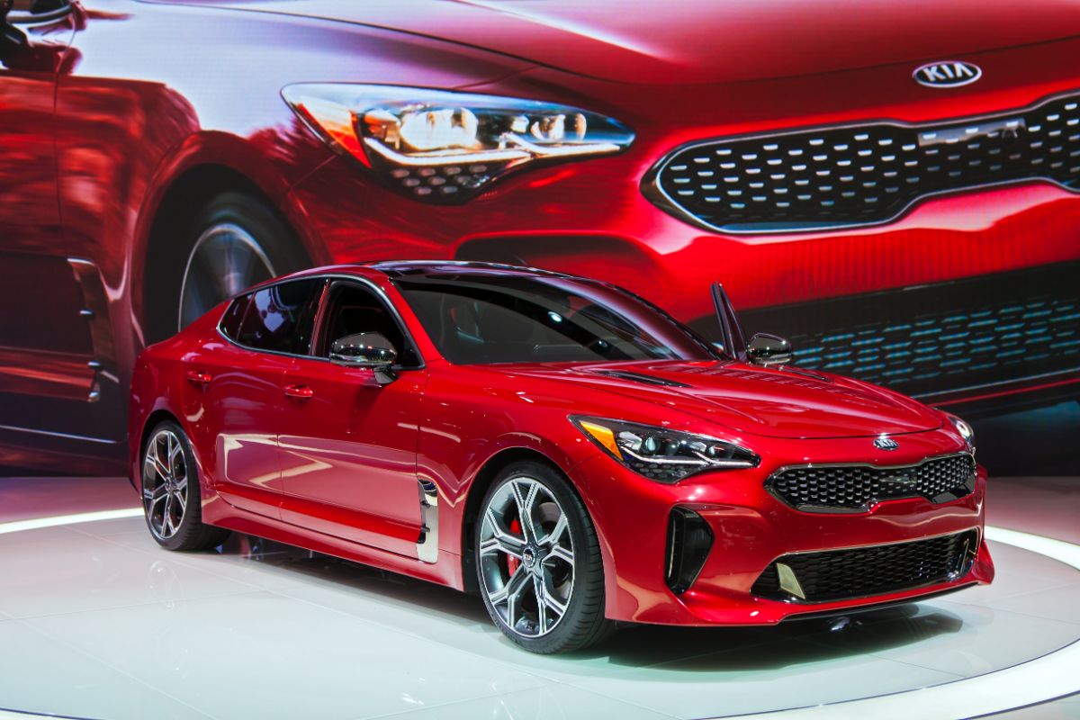 A glossy red Kia Stinger on display at the Auto Show.